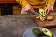 © Wavebreak Media - Hands of indian man preparing sandwiches with avocado in kitchen at home, copy space