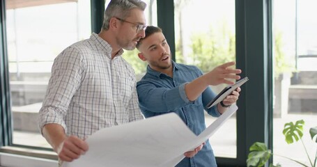 Wall Mural - two diverse mele architects with digital tablet and a plan discussing at office