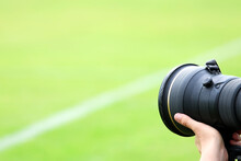 A Professional Photographer At A Football Field Or Sporting Event