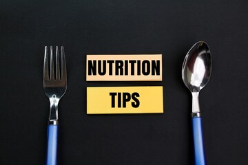 spoon and fork with nutrition tips. the concept of taking care of food. tip concept for nutrition