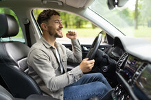 Young Man Smiling Happy Doing Ok Sign Driving Car.