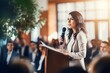 © Salsabila Ariadina - Businesswoman speaking in front of audience in seminar indoor