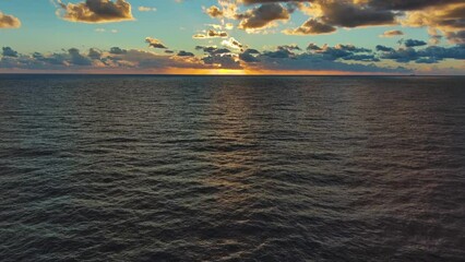 Wall Mural - aerial view of sea surface during a beautiful colourful sunset, 4k