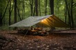 waterproof tarp shelter set up in a wooded area
