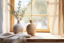 A Vase And Pot Sitting On A Table On The Window Sill