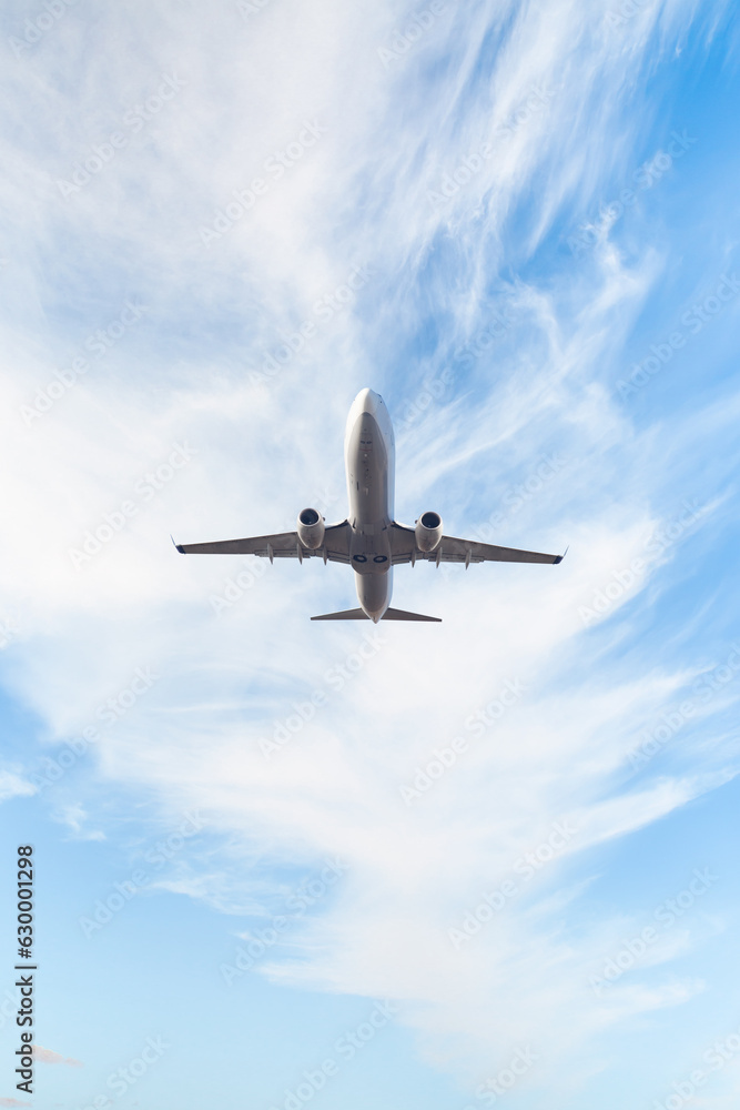 White passenger airplane flying in the sky amazing clouds in the ...