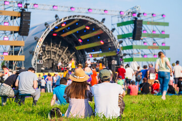 Crowd in front of stage at music concert on sunny day