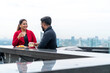 © CandyRetriever  - Indian business man and woman company teamwork employee enjoy and fun celebration party drinking and toasting glass after success corporate business project at outdoor rooftop restaurant bar.