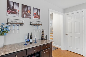 Canvas Print - Home bar with wine glasses and pictures on the wall.