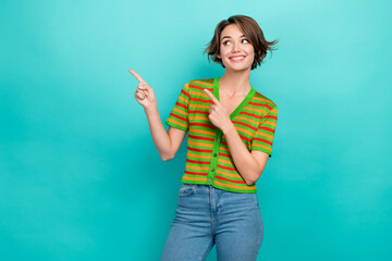 Photo of dreamy sweet lady wear striped cardigan looking showing two fingers empty space isolated teal color background