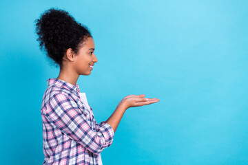 Poster - Photo of cute pretty lady wear plaid shirt looking holding arms empty space isolated blue color background