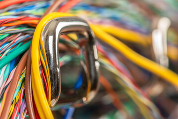 Wall Mural - Colored electrical cable on hook of organizer, macro view with blurred background
