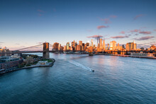 Manhattan Skyline And Brooklyn Bridge At Sunrise, New York City, USA
