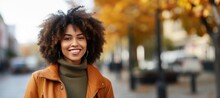 Portrait Of A Beautiful Black Woman In Front Of A Autumn City Background In The Fall