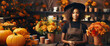Attractive african american woman florist working in flower shop. Creation of autumn decor for Halloween celebration