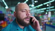 © Marco - Suspicious Man on Phone with Intense Concentration, Casual Individual Listening Intensively with Smartphone in ear