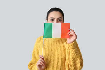 Sticker - Young woman with flag of Ireland on grey background