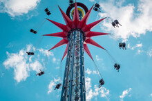A Spinning Extreme Attraction Against The Blue Sky In The Amusement Park Of The City Of St. Petersburg.