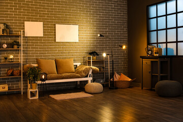 Canvas Print - Interior of dark living room with couch, shelving units and glowing lamps