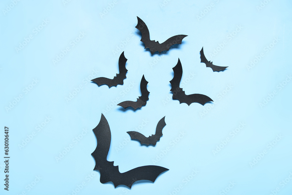 Paper bats for Halloween party on blue background