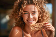 Beautiful health-conscious and active young woman savoring a nutritious crunchy protein bar made from edible insects, a sustainable and eco-friendly protein source.