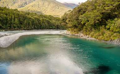 Wall Mural - Nestled among mature beech and podocarp forest, these pools of deep, clear water flowing into the Makarora River offer a moment of tranquillity. This is one of our best short walks