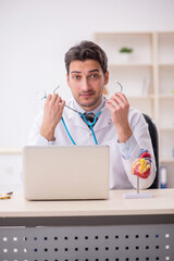 Sticker - Young male doctor cardiologist working in the clinic