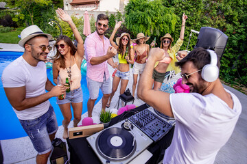 Wall Mural - Group of  friends having fun at pool party