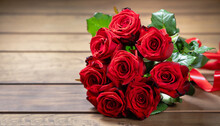 Red Roses Bouquet Put On Wooden Table. For Valentine's Day.
