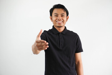 smiling young asian man wearing black polo t shirt doing hand shake gesture for agreement isolated on white background