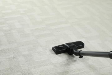 Canvas Print - Removing dirt from white carpet with modern vacuum cleaner. Space for text