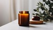Burning candle mockup, styled home interior decor with amber glass candle jar.