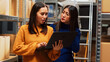 © DC Studio - Female employees looking at logistics on laptop, working with quality control and supply chain management. Two women planning shipment, small business development in storage room.