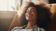Happy afro american woman relaxing on the sofa at home portrait , Smiling girl enjoying day off lying on the couch , Healthy life style, good vibes people and new home concept