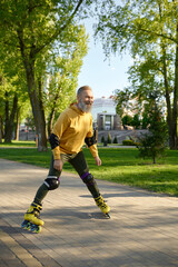 Wall Mural - Happy mature man rollerskating on pathway in city park