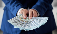 Businessman, Hands And Money Fan Of Dollars For Banking, Trading Bills And Investment Budget Or Financial Freedom. Closeup Of Rich Trader, Profit And Income Of Bonus, Pay Cash Or Accounting Of Wealth