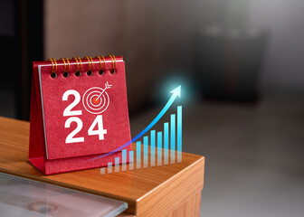 Wall Mural - Happy new year 2024 banner background. Virtual rising growth graph and 2024 numbers year with target icon on red small desk calendar cover standing on wood table. Business goals and success concepts.