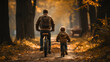 Rear view of a boy riding a bicycle whit his father next to him. Father teaching his son to ride a bicycle.