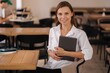 © Aleksandr - Portrait of business lady hold digital tablet. Female sitting in cafe. Freelancer concept. Financial manager