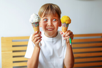 The blond boy surprised with two ice creams