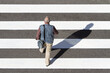 Top view of s Senior man walking on a zebra crossing