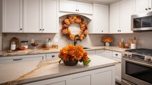 A Luxury Kitchen With Marble Countertop And Orange Autumn Decor