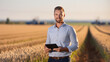 © Studio Nova - Man farmer standing the field of wheat and using tablet computer. Agricultural concept.