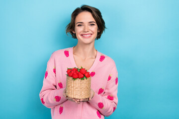 Photo of sweet tricky woman dressed pink stylish clothes hands hold basket gathering red ripe berries isolated on blue color background