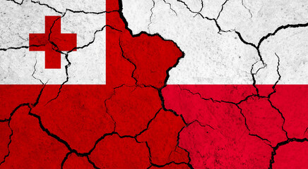 Flags of Tonga and Poland on cracked surface - politics, relationship concept