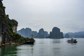 Wall Mural - Aerial view of a cruise ship navigating through Halong Bay in Vietnam, Southeast Asia