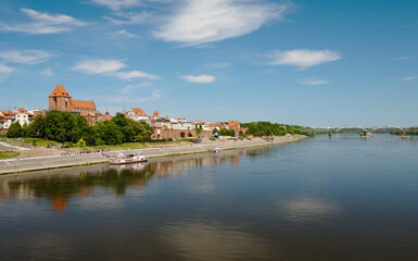 Wall Mural - Panorama of Torun, old medieval town in Poland. Tourist boats on Vistula river with panorama of old town Torun in summer day.