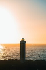 Sticker - Image shows a picturesque sunrise over an iconic lighthouse in Iceland