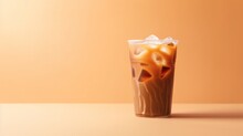Iced Coffee On Plastic Cup, Isolated On Orange Pastel Color Background.