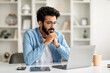 © Prostock-studio - Young Indian Man Reading Email On Laptop While Working In Home Office